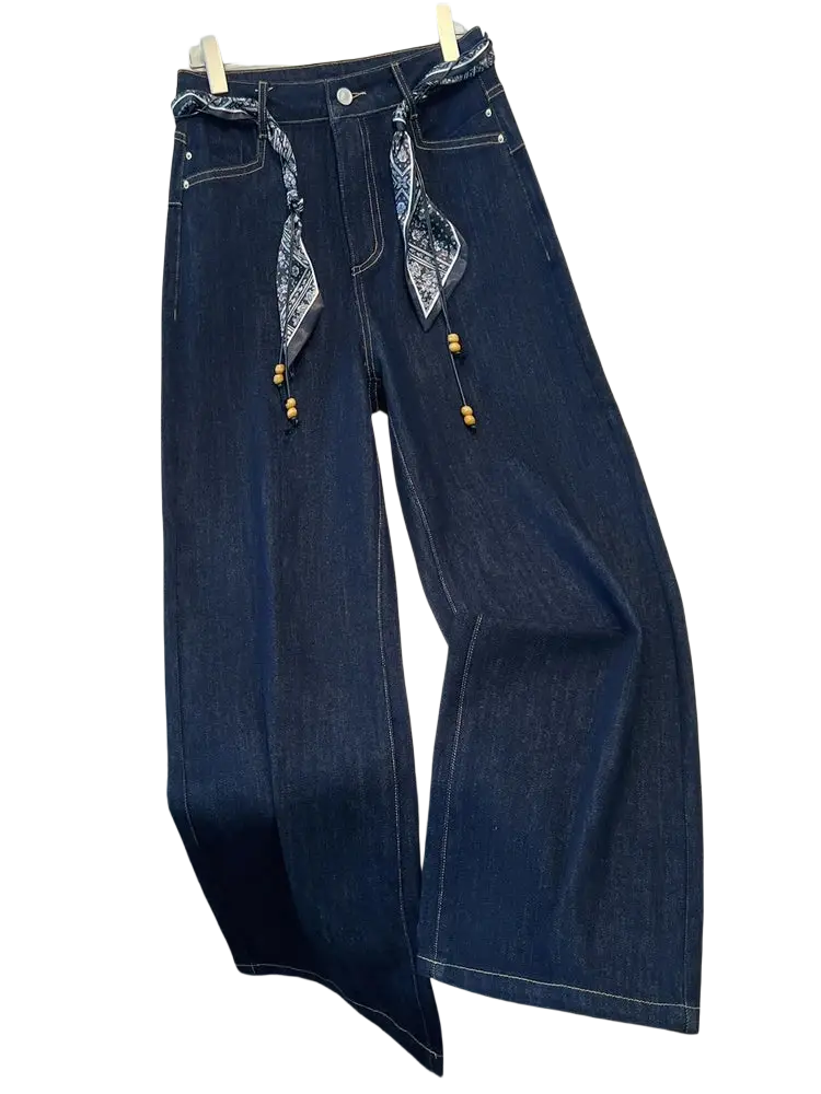 Wide leg dark blue denim jeans with decorative bandana scarf belt and wooden beads tied at the waist