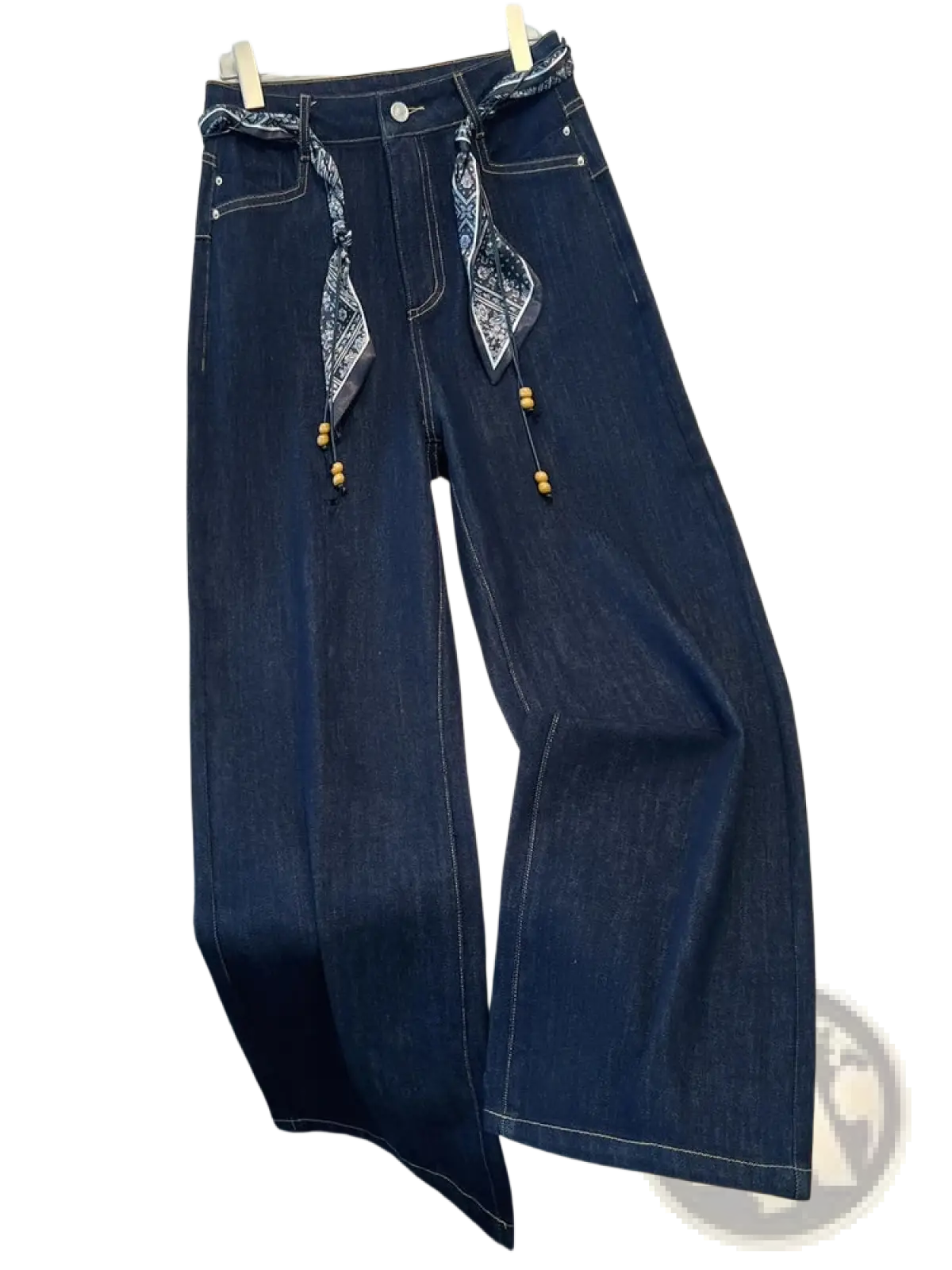 Wide leg dark blue denim jeans with decorative bandana scarf belt and wooden beads tied at the waist