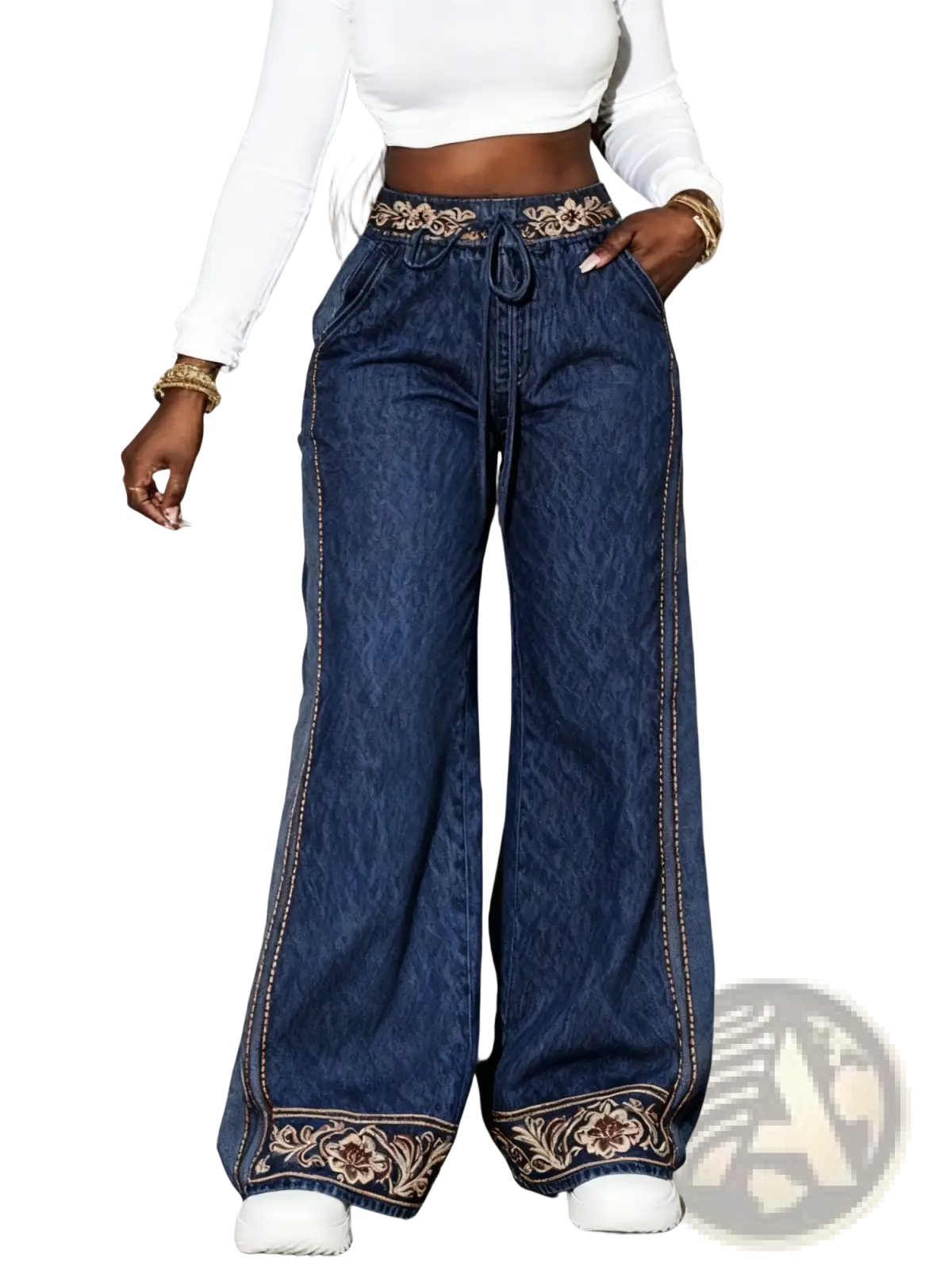 Wide-leg denim pants in blue with a high-waisted drawstring and embroidered floral patterns on waistband and hem