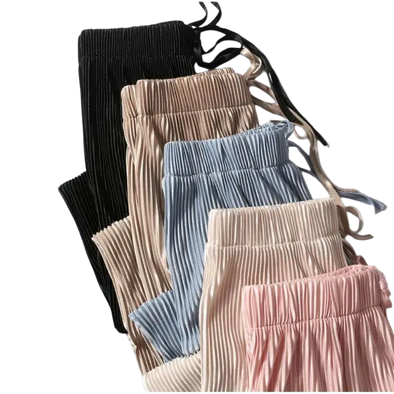A collection of lightweight wide leg pleated summer pants for women in pastel tones with elastic waist drawstring bands