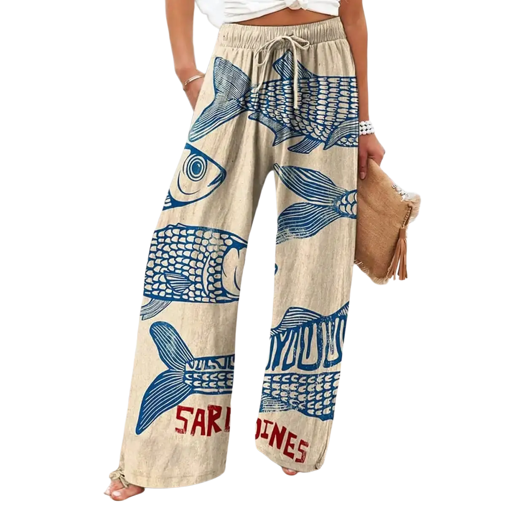 Beige wide leg pants with elastic waist featuring bold blue fish print and red sardines text at the hem