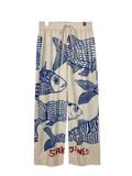 Beige wide leg fish print pants with elastic waist and red sardines lettering at the bottom