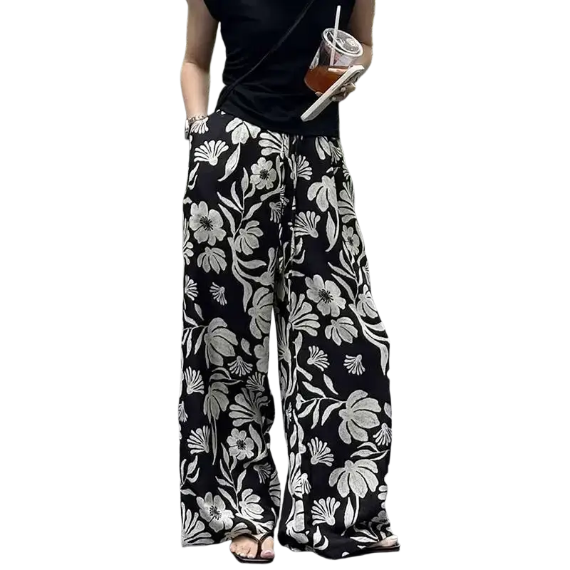 Black wide leg pants for women featuring a bold white floral pattern perfect for stylish casual wear