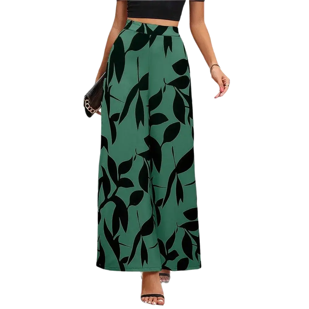Wide leg floral summer palazzo trousers with green leaf pattern and black silhouettes on flowing fabric