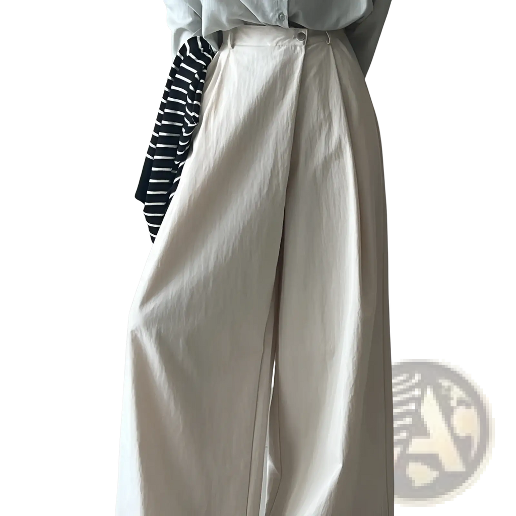 Cream-colored wide leg high waisted casual trousers with a relaxed flowing silhouette and soft fabric texture