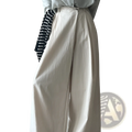 Cream-colored wide leg high waisted casual trousers with a relaxed flowing silhouette and soft fabric texture