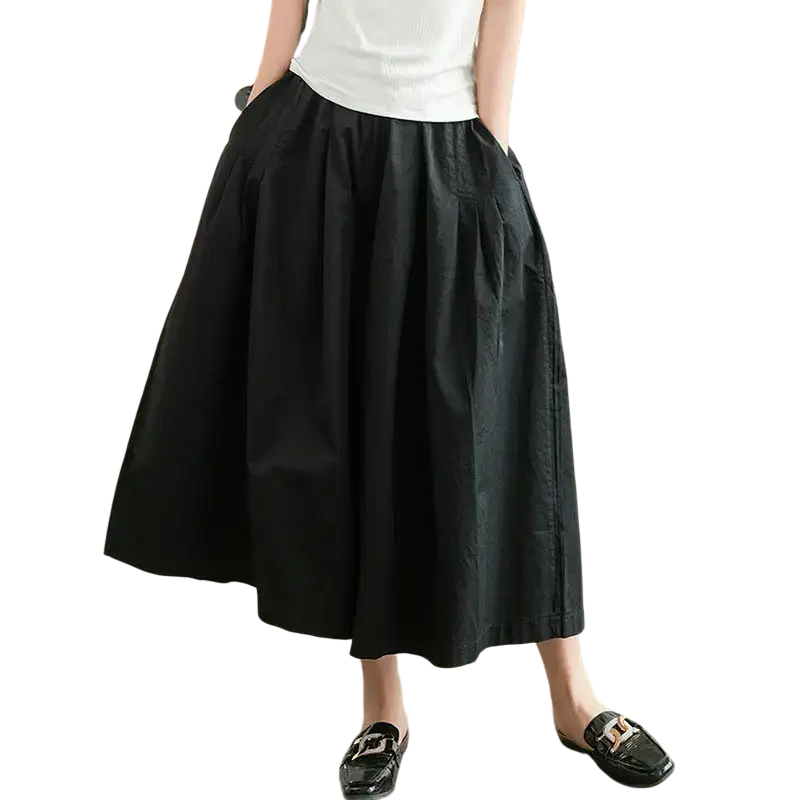 Black cotton wide leg pants skirt pants with a pleated midi skirt design and relaxed flowing silhouette