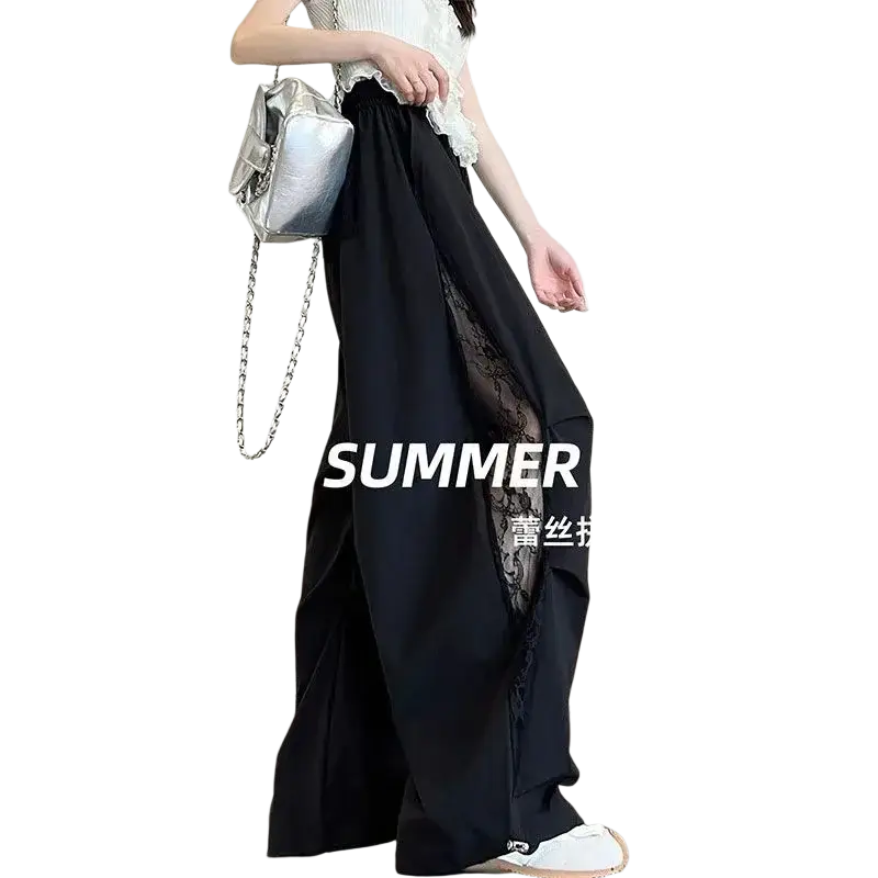 Silver chain-strap handbag with shiny metallic finish and structured shape paired with wide leg pants elastic waist