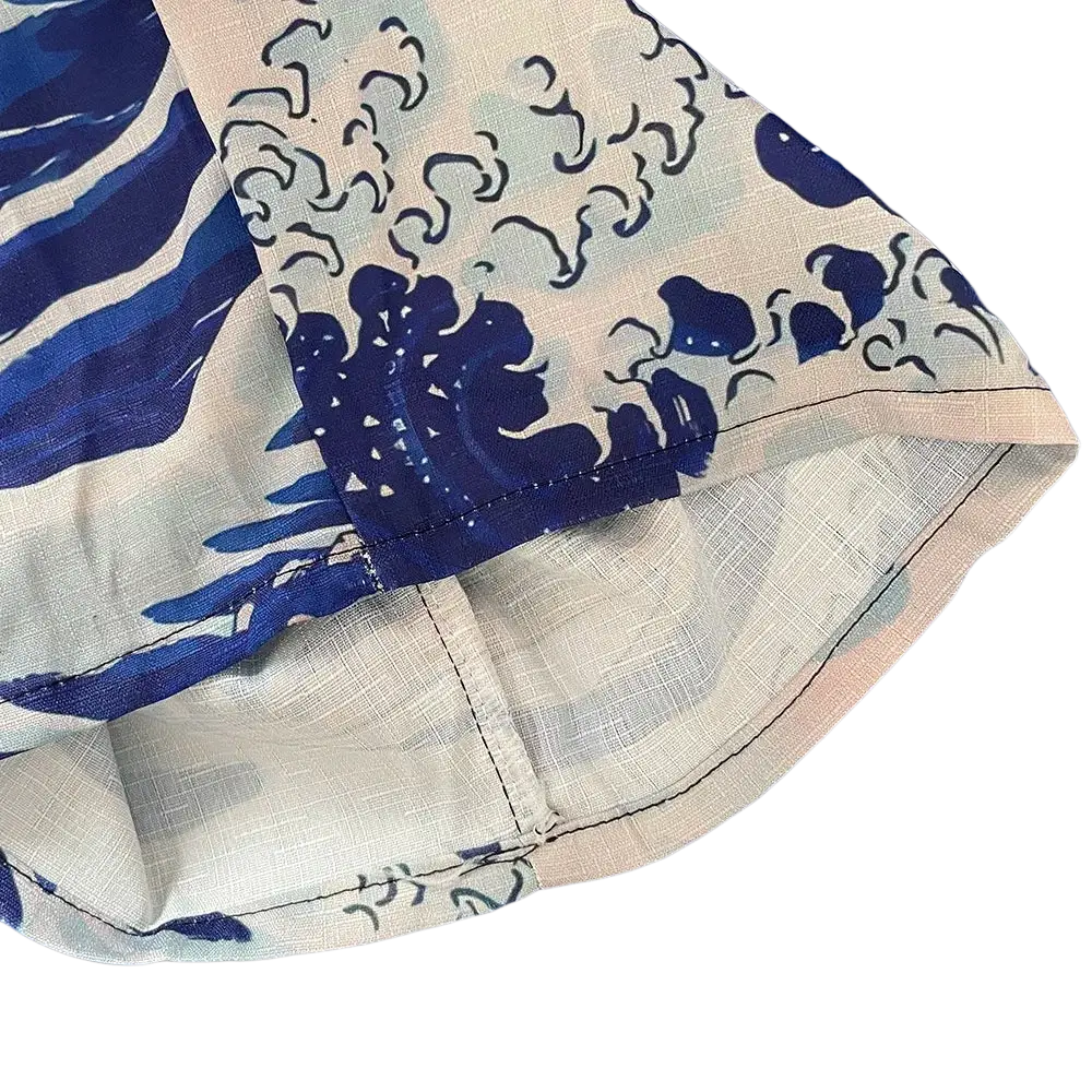 Light blue and white wide leg pants with bold dark blue wave pattern and intricate hem stitching for casual wear