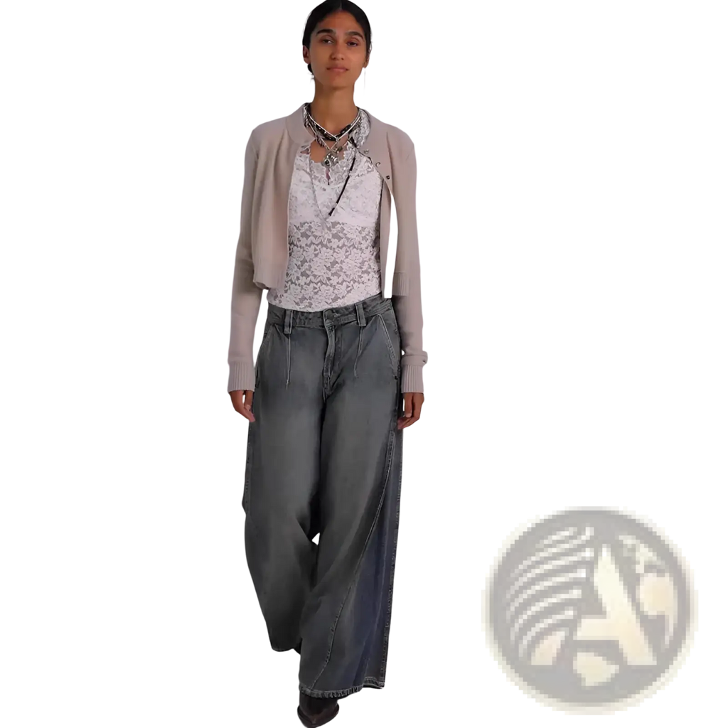 A woman wearing vintage blue wide leg retro denim jeans paired with a beige cropped cardigan and white lace top