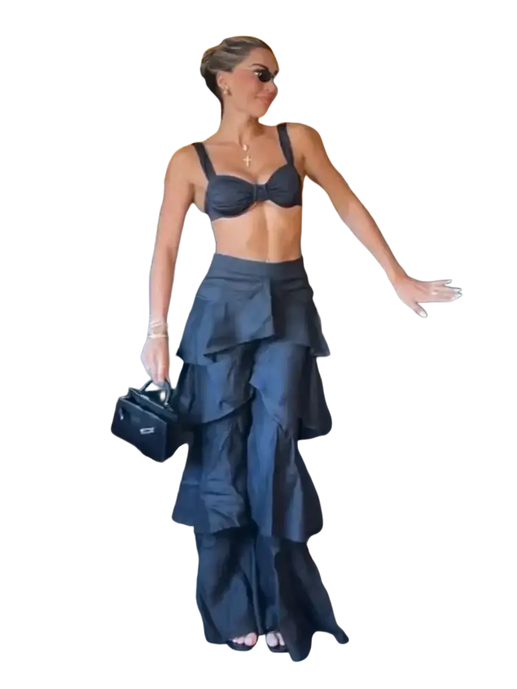 Black mini handbag with small logo paired with wide leg ruffled high waist black y2k streetwear pants