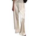 Cream wide leg satin pants with elastic waist featuring a relaxed flowing silhouette and full pants length