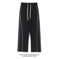 Black wide leg striped track pants with white side stripes and matching drawstring waistband for casual wear