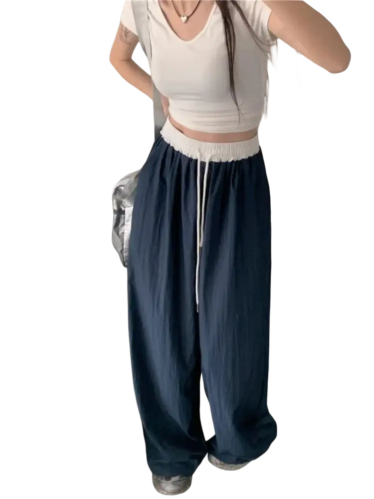 Navy blue wide leg sweatpants for women with a white elastic waistband and adjustable drawstring for comfort
