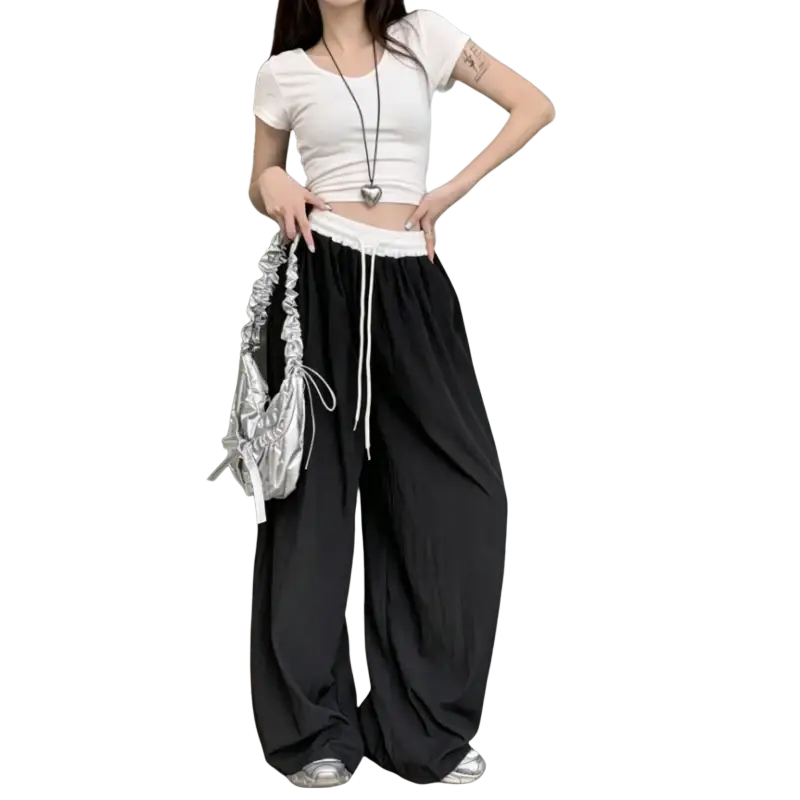 Silver metallic ruched shoulder bag with drawstring closure paired with wide leg sweatpants for women
