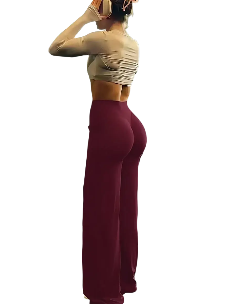 A pair of deep maroon high waist workout leggings in smooth stretchy fabric designed for fitness and wide leg comfort