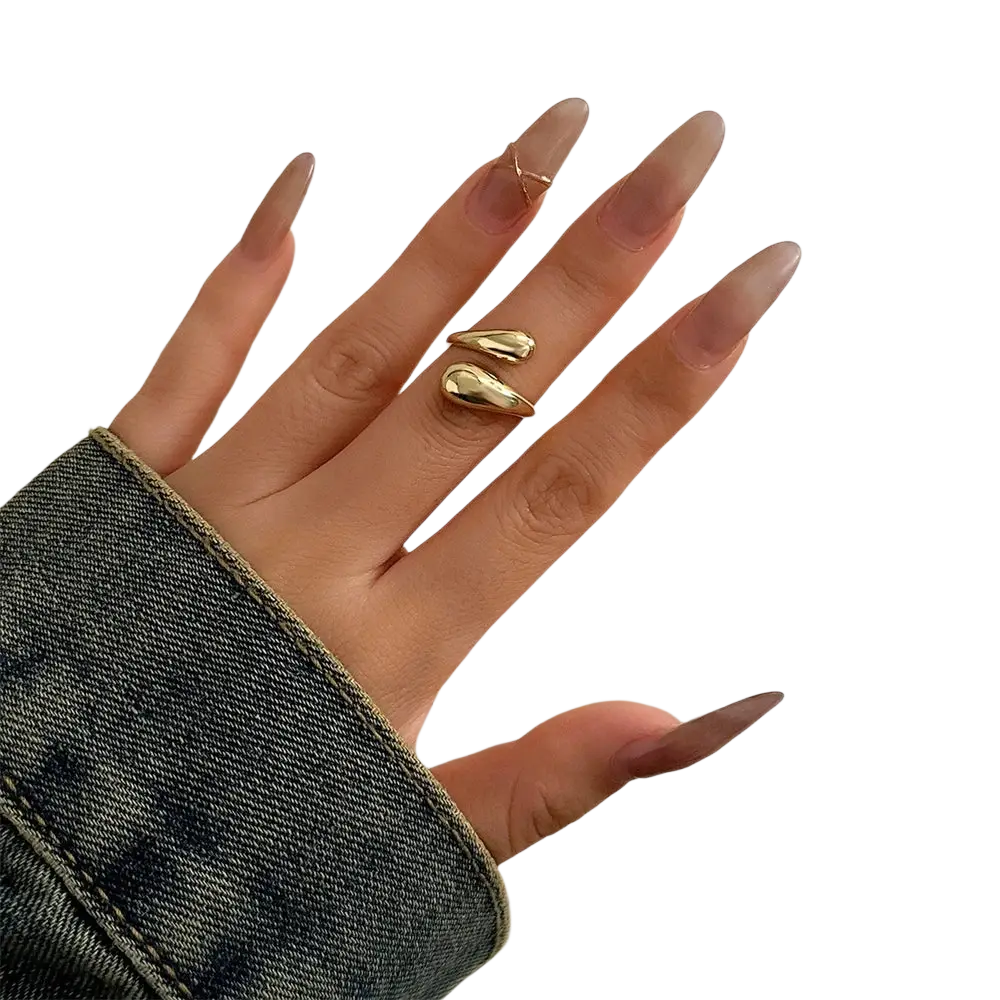 Gold-toned sleek metal bangle ring with smooth curved design worn on middle finger in silver color chunky style