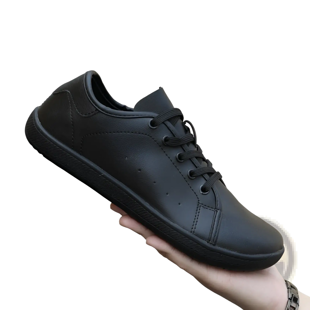 Black leather low-top wide toe shoes with matching laces and textured rubber sole minimalist non slip sneakers