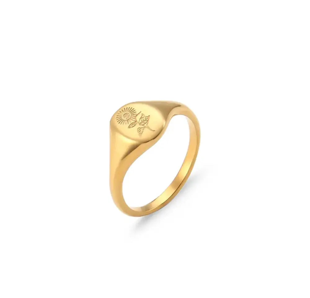 Wildflower engraved gold signet ring featuring a sun and flower design on its flat rounded face made of gold
