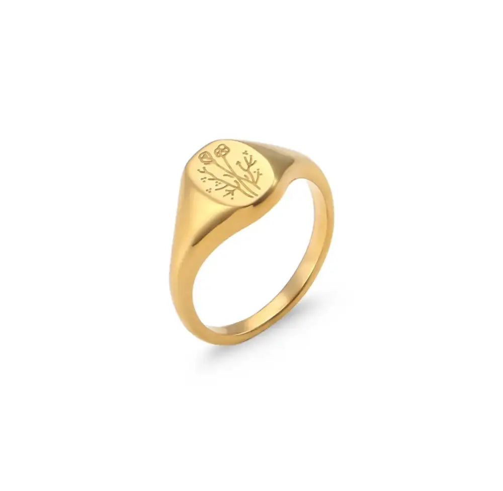Gold wildflower engraved signet ring featuring an oval face with floral design in a polished finish
