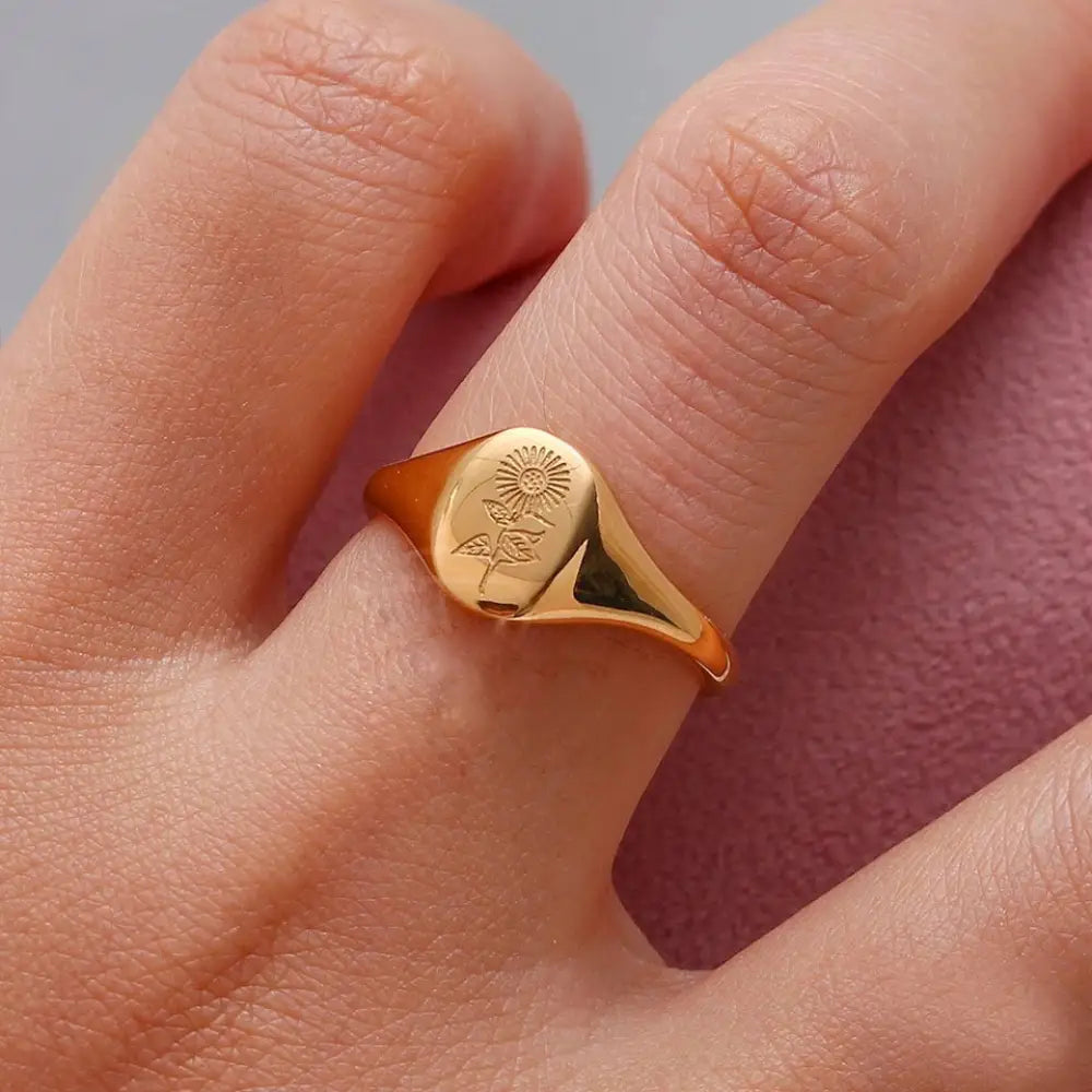 Wildflower engraved gold signet ring set featuring a gold-toned rectangular face with a sunflower engraving
