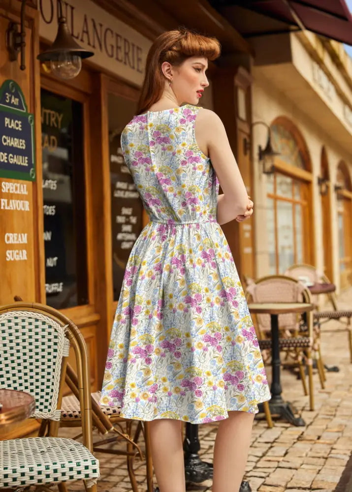 Wildflower vintage 1950s cotton floral midi dress with pockets featuring pastel lavender pink and yellow flowers on light blue fabric