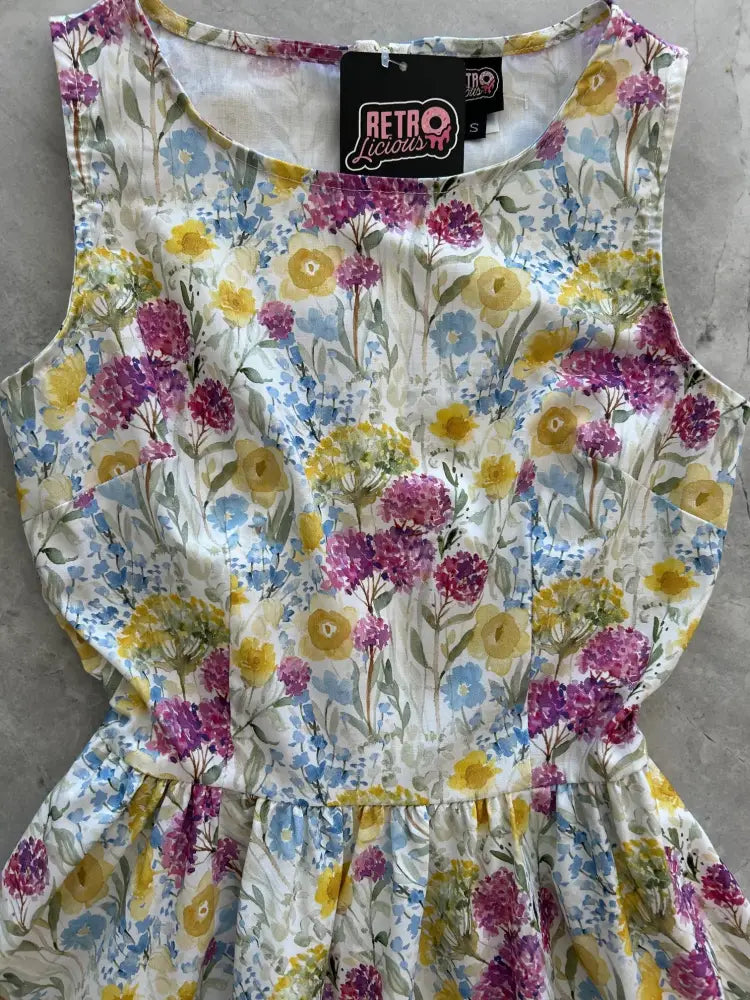 Wildflower vintage 1950s sleeveless cotton midi dress with pockets featuring vibrant purple yellow and blue floral pattern