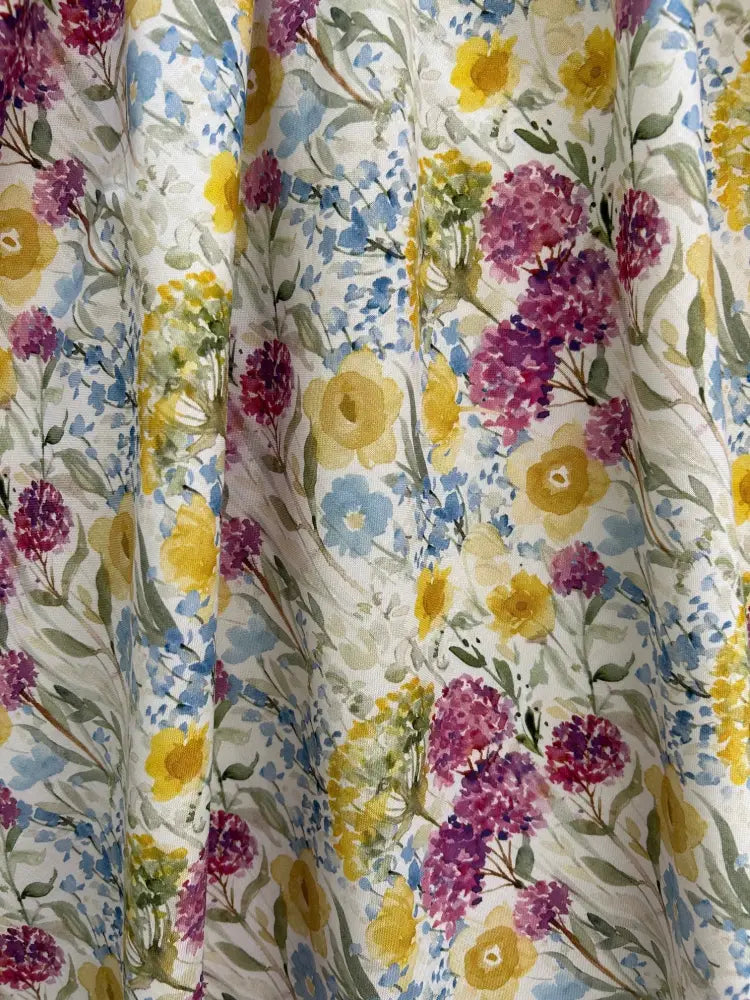 Wildflower vintage 1950s cotton floral midi dress with pockets featuring vibrant purple and yellow watercolor blossoms on cream