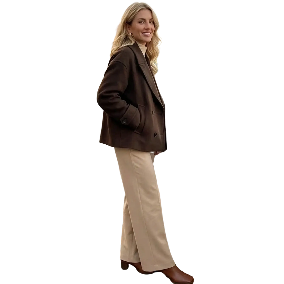 A woman wearing a brown wool willshela double breasted trench jacket paired with beige wide-leg trousers