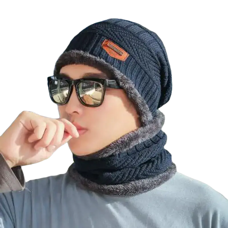 Dark blue knitted winter beanie with fuzzy gray lining and orange brand patch viewed on official website