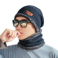 Dark blue knitted winter beanie with fuzzy gray lining and orange brand patch from the official website