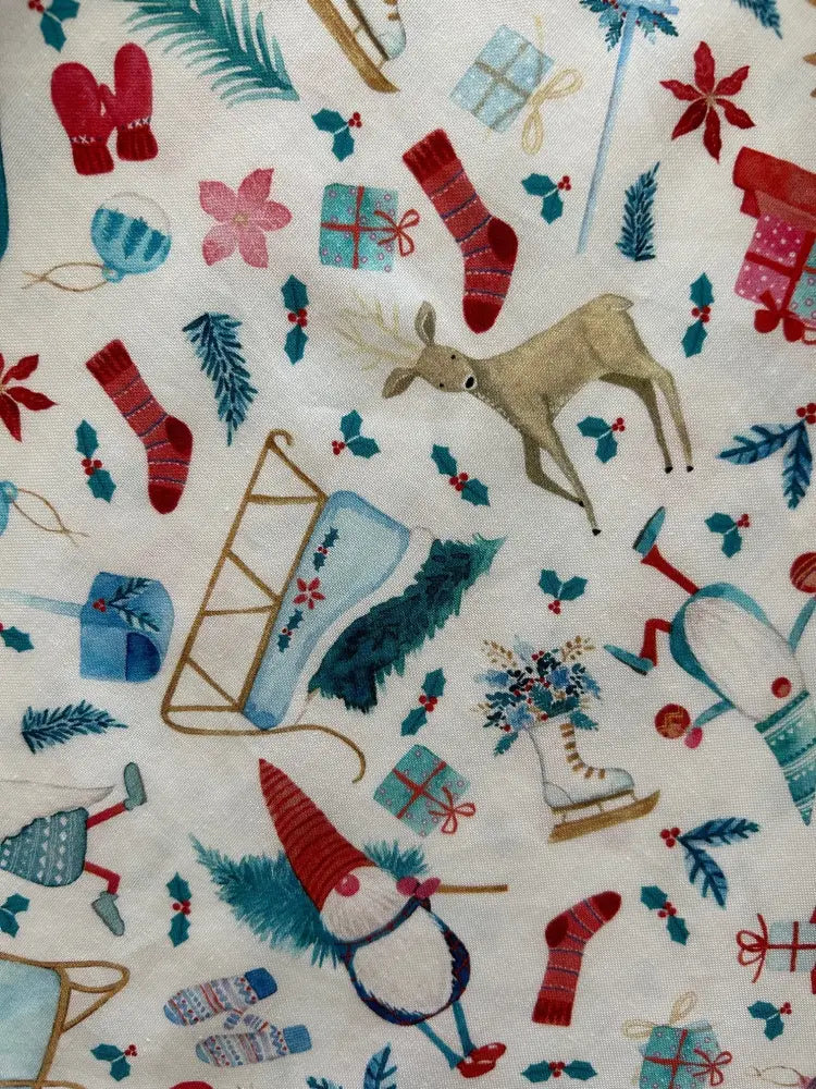 Winter cheer vintage 1950s cotton christmas dress fabric with red mittens striped socks reindeer and gnome on off-white background