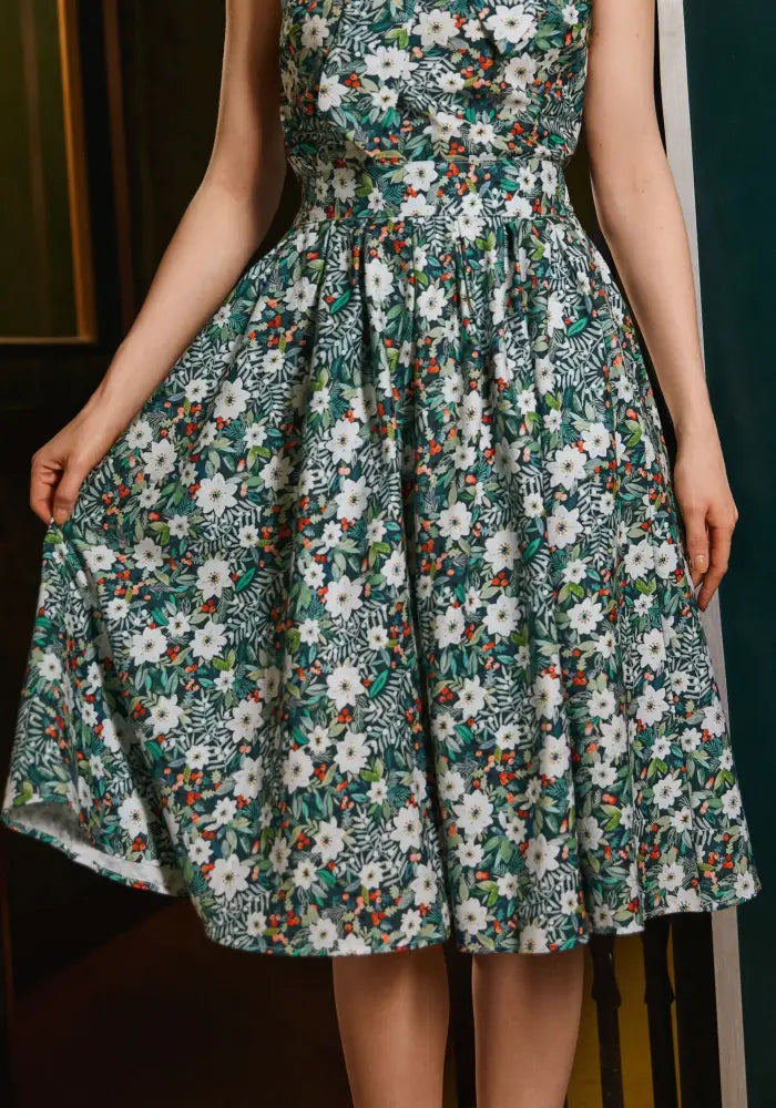 Winter floral Doris retro cotton midi skirt with pockets in green and white floral print with red accents and sleeveless design