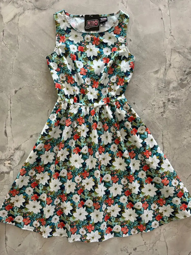 Winter floral 1950s cotton sleeveless midi dress with pockets featuring white and red flowers on a teal background