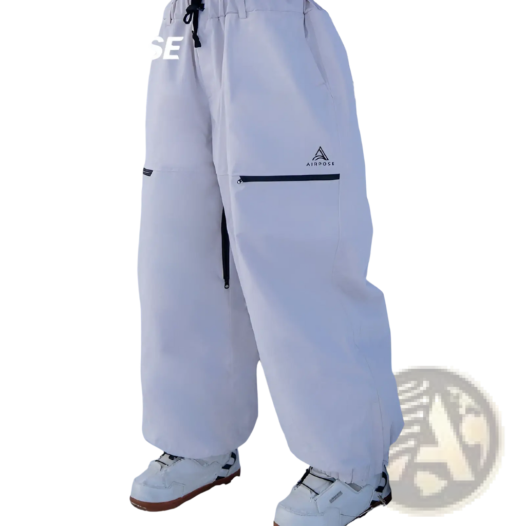 White air pose snow pants with black zipper accents and branded logo on thigh designed for winter outdoor skiing