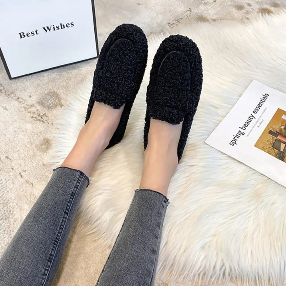 Black plush faux shearling winter loafers with soft fuzzy surface and chunky sole for cold weather comfort