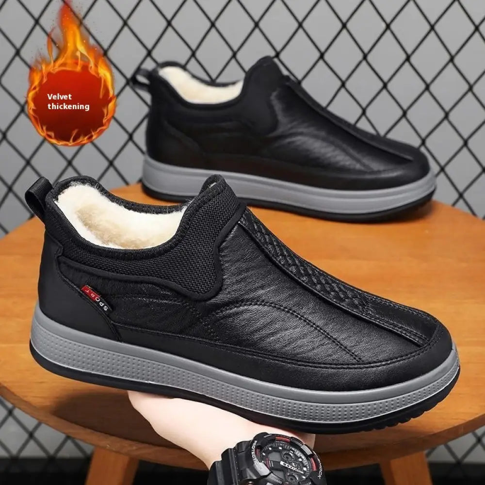 Men’s fleece lined slip on winter snow boots with black textured leather upper, plush white lining, and gray rubber sole