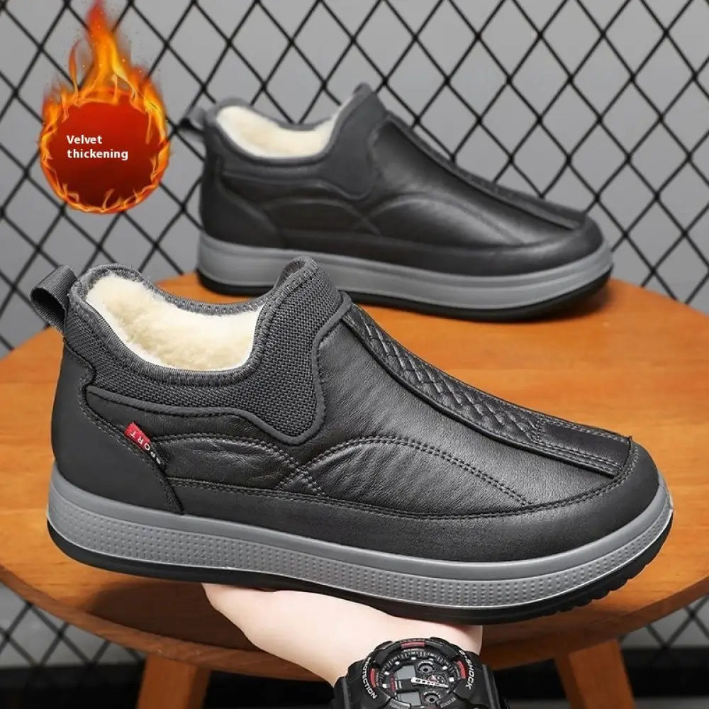 Men’s black leather slip-on winter snow boots with quilted detailing and plush white fleece lining for cold weather