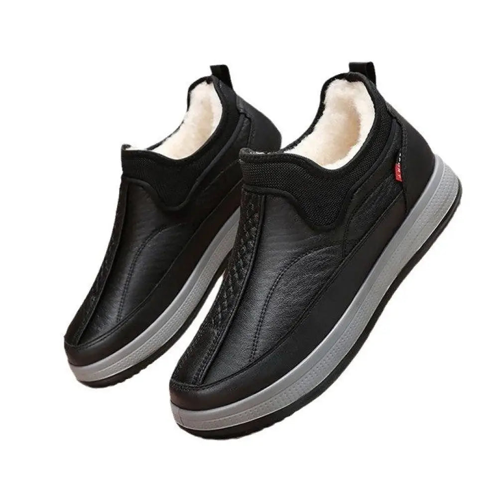 Men’s fleece lined slip on winter snow boots in black leather with plush white lining and gray rubber soles