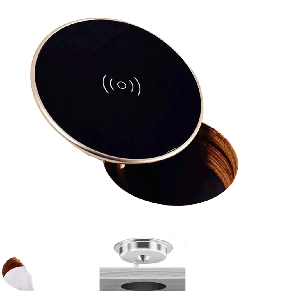 Black circular wireless charger with silver metallic rim and white symbol built into wooden desktop for fast charging