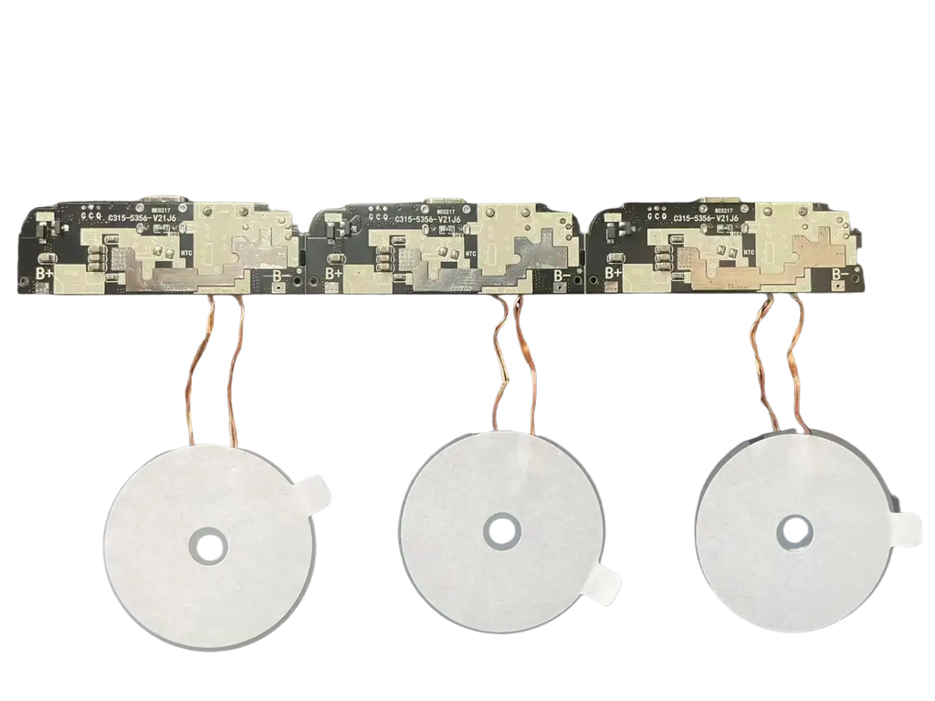 Three white circular wireless charging coils with copper wires on black circuit boards for 15w fast charging pcba