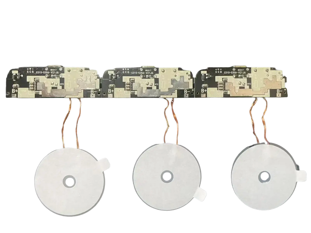 Three white circular wireless charging coils with copper wires and circuit boards in a 15w fast charging module pcba