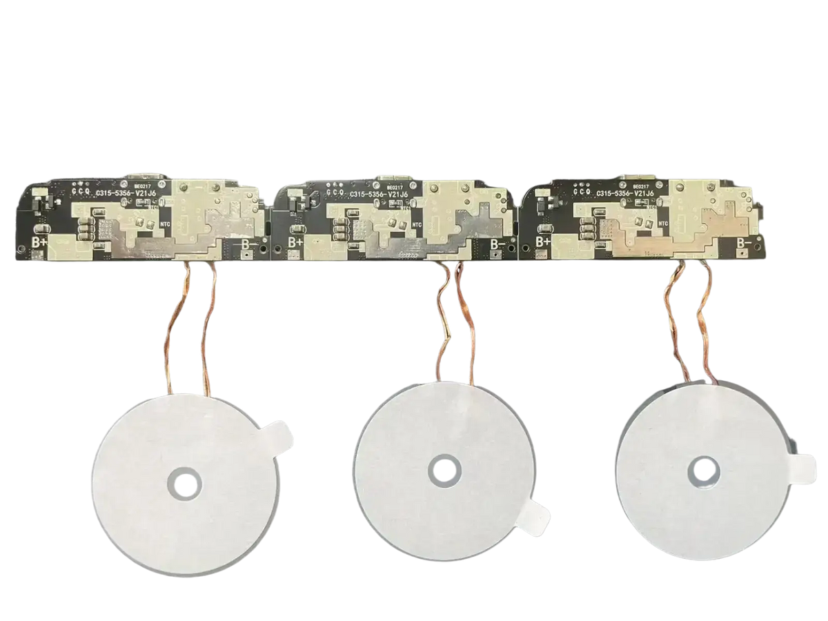 Three white circular wireless charging coils with copper wires and circuit boards in a 15w fast charging module pcba