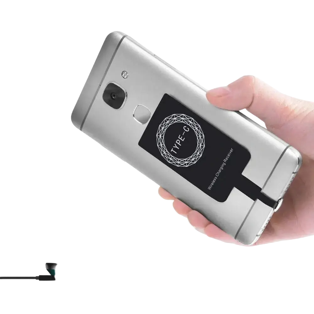 Silver android smartphone back with black type-c wireless charging receiver attached for wireless charging use