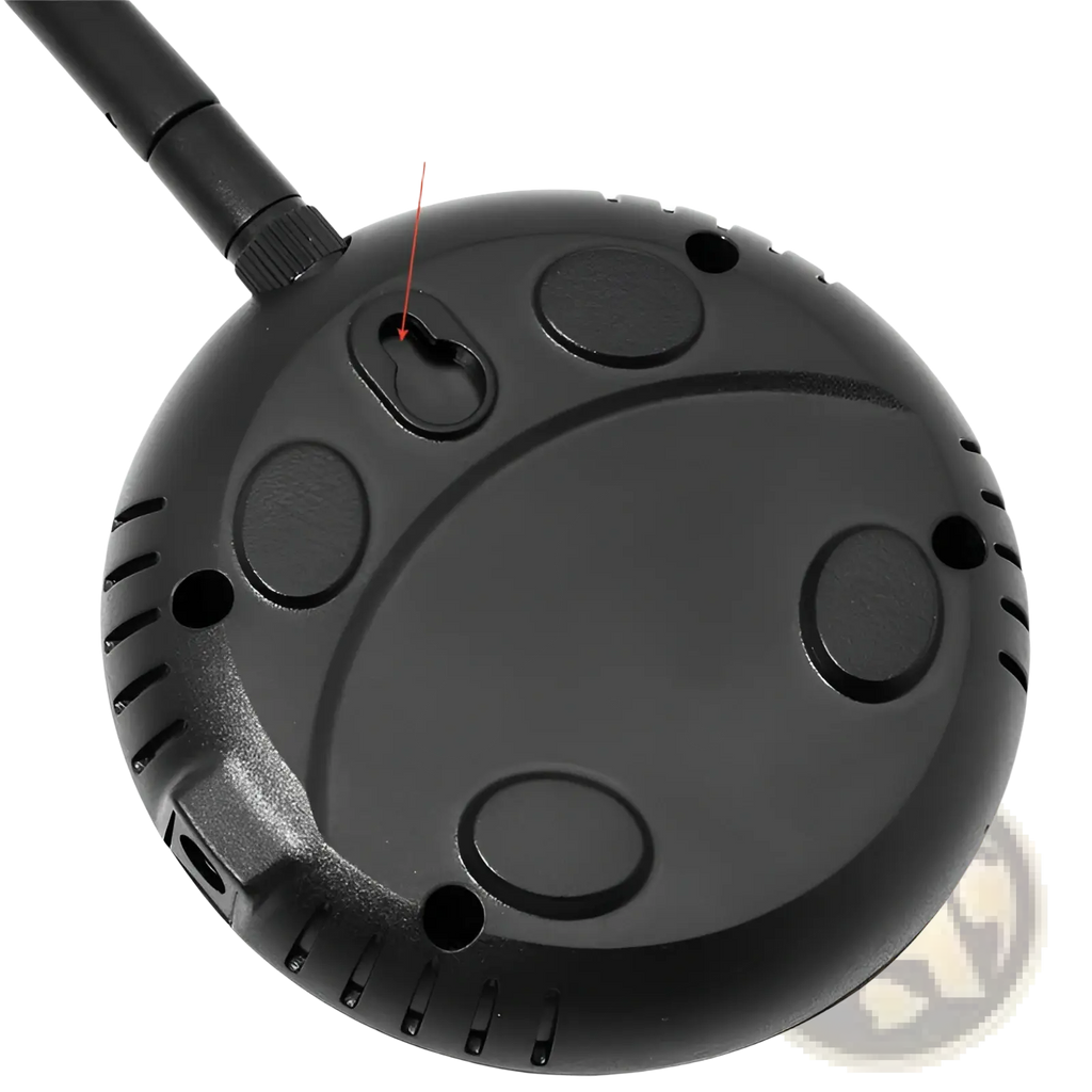 Black circular wireless pet fence transmitter with textured surface and multiple mounting holes for training collar use