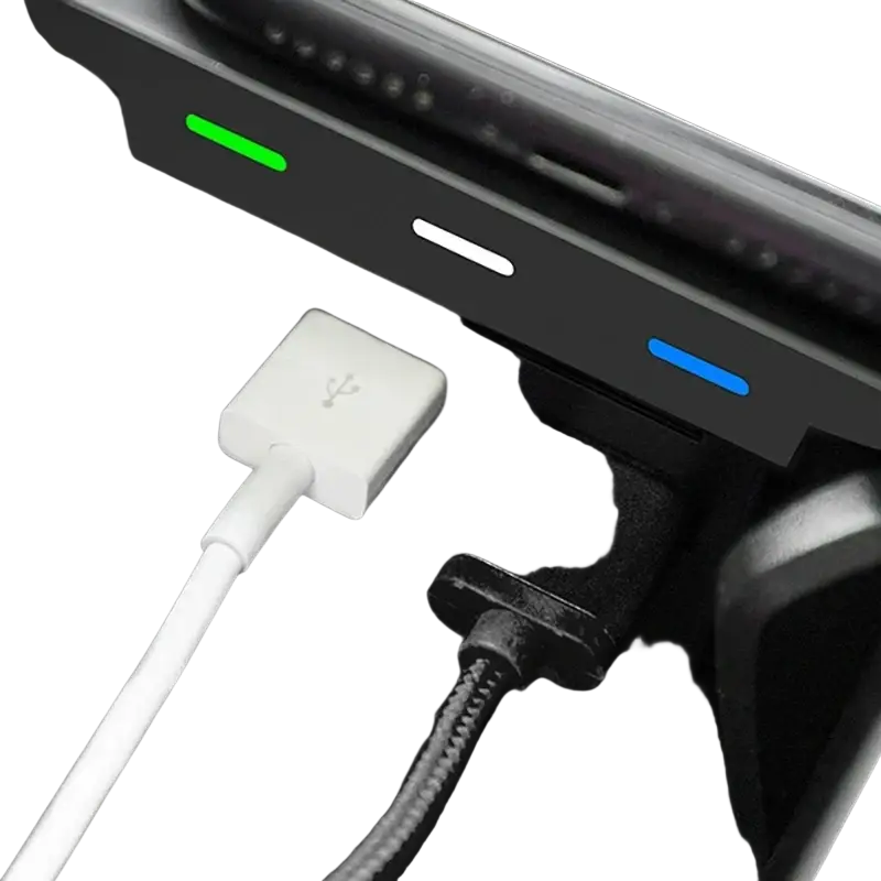 Black and white usb wireless phone charger adapters with green white and blue lights plugged into volvo xc90 power outlet