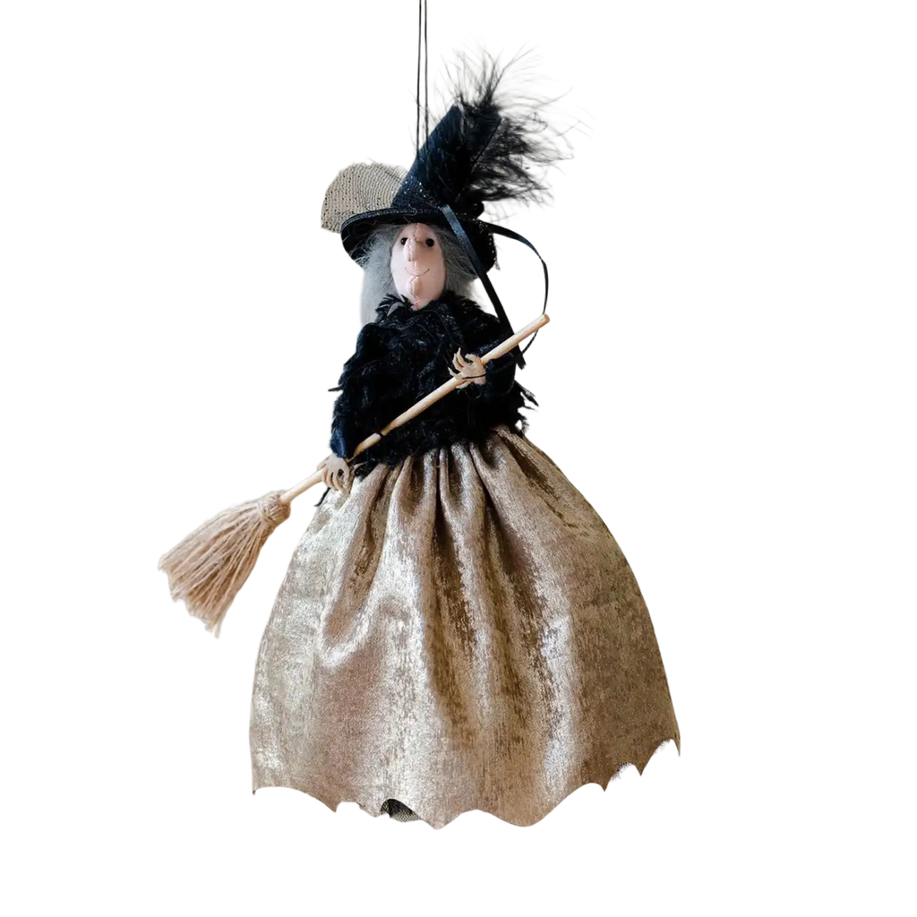Witch doll halloween hanging tree ornament with black feathered hat, black textured bodice, and shimmering gold skirt