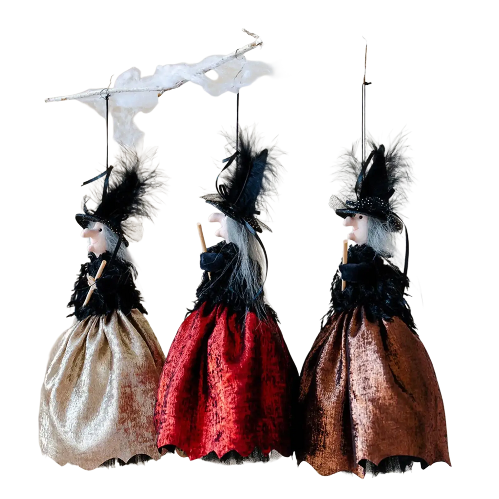 Three halloween witch dolls with black feathered hats white hair and velvet skirts in gold red and bronze hanging ornaments