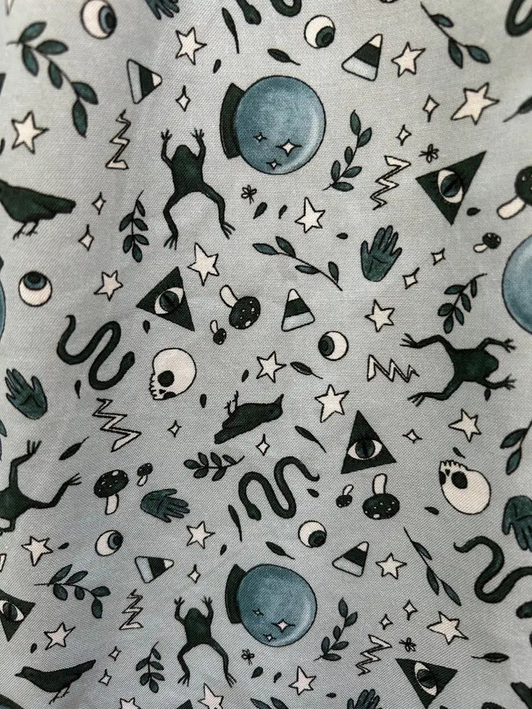 Light gray cotton witching hour retro fit and flare dress with whimsical black and white frog and star pattern