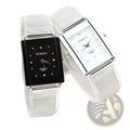 A pair of womage rectangular silver mesh quartz watches with black and white faces adorned with rhinestones